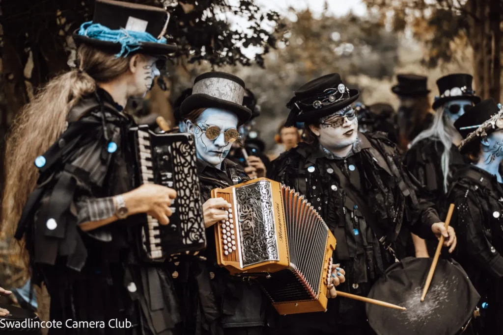 Three Boggart musicians, playing (from left to right) accordion, melodeon, and drum.